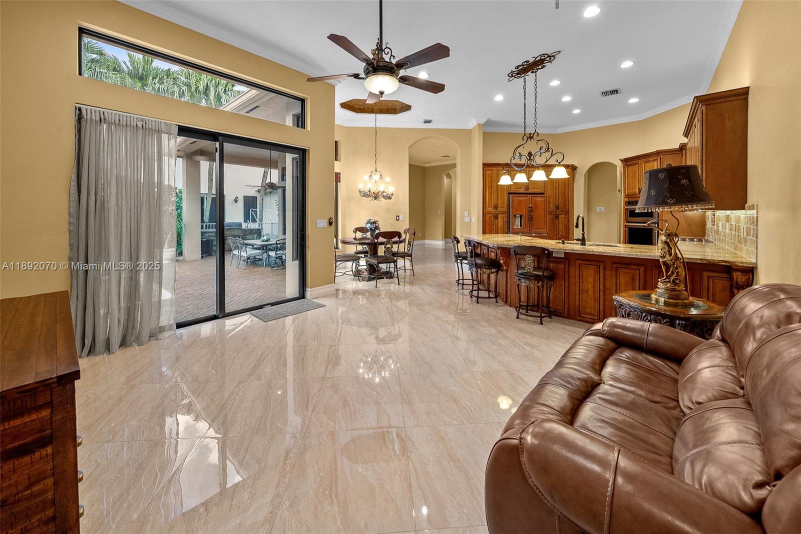 19230 Southwest 30th Street Miramar, FL 33029 - Photo 29 of 45 a living room with furniture a large window and chandelier