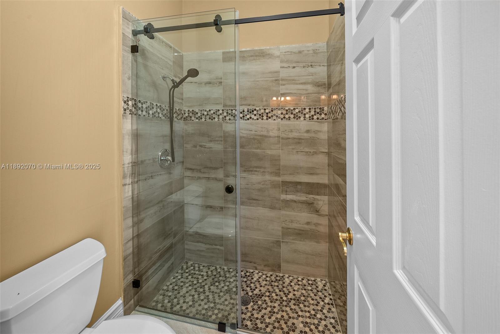 19230 Southwest 30th Street Miramar, FL 33029 - Photo 34 of 45 a bathroom with a shower and toilet