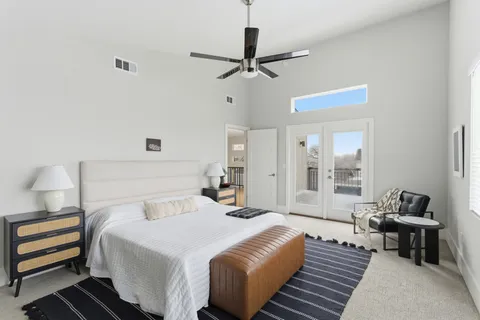 a bedroom with a large bed and a large window