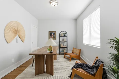 a view of a dining room with furniture and wooden floor