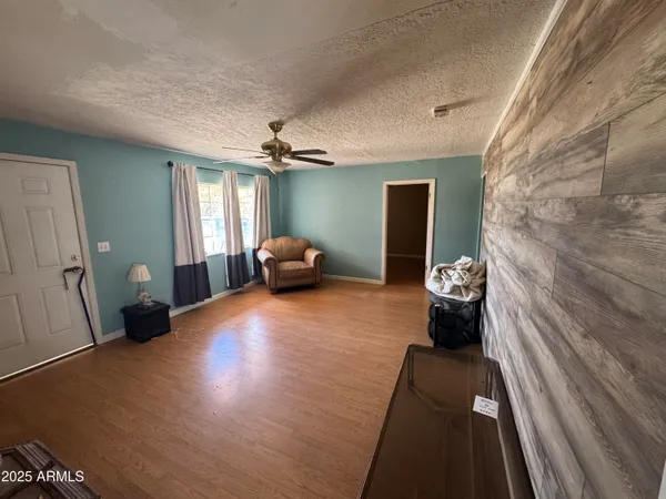 a view of a livingroom with furniture and a ceiling fan