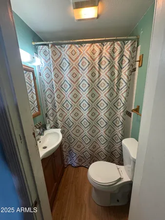 a white toilet sitting next to a bathroom sink and a tub