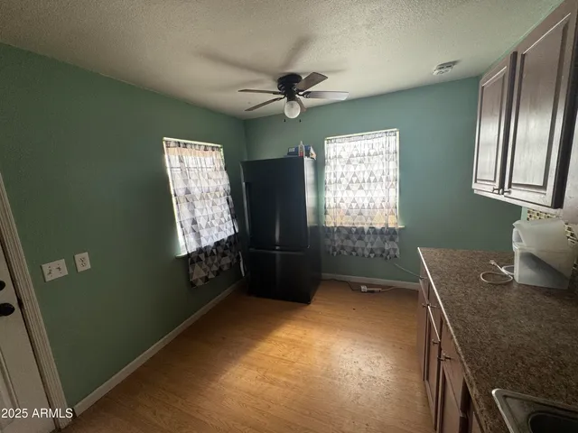 a view of a balcony with wooden floor and a floor to ceiling window