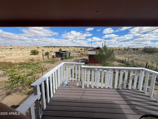 a view of balcony with wooden floor and outdoor seating