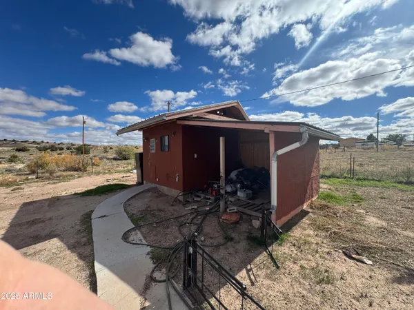 a view of a house with yard and sitting area