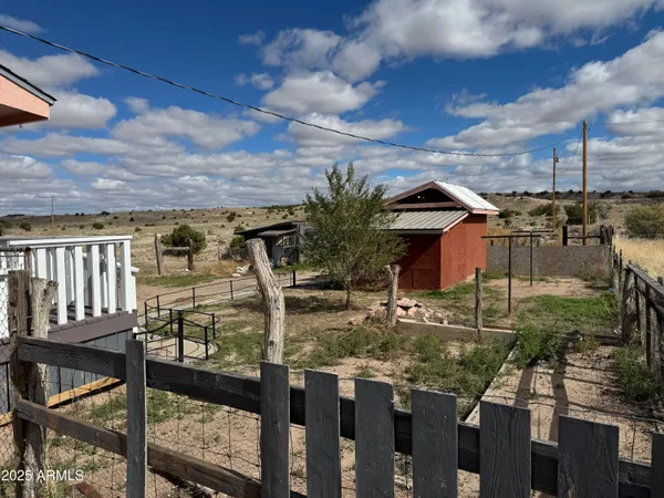 a view of a house with backyard and porch