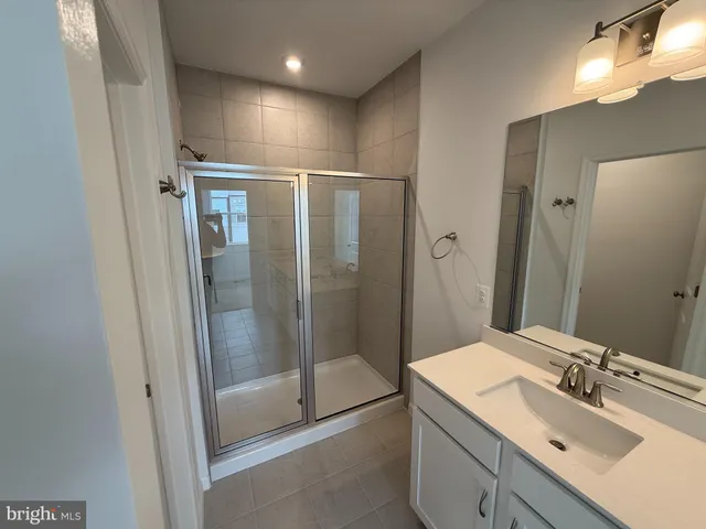 a spacious bathroom with double vanity sink and a mirror