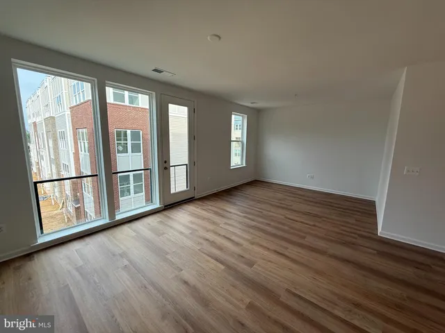 a view of kitchen with microwave stove refrigerator and cabinets
