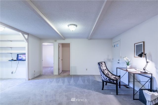 a view of a livingroom with furniture and a fireplace