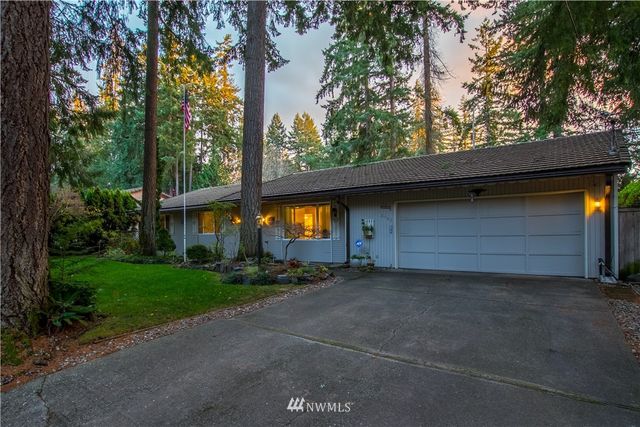 a view of a house with a yard and garage
