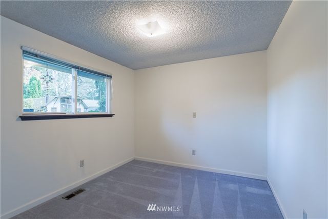 a bathroom with a double vanity sink toilet and shower