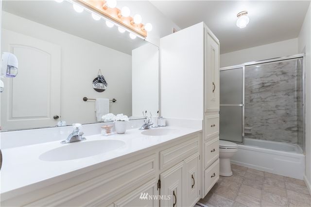 a view of backyard with deck and outdoor seating