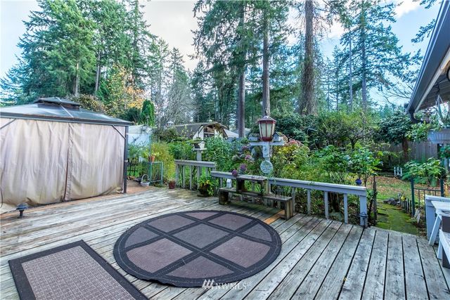 a backyard of a house with lots of green space and wooden fence