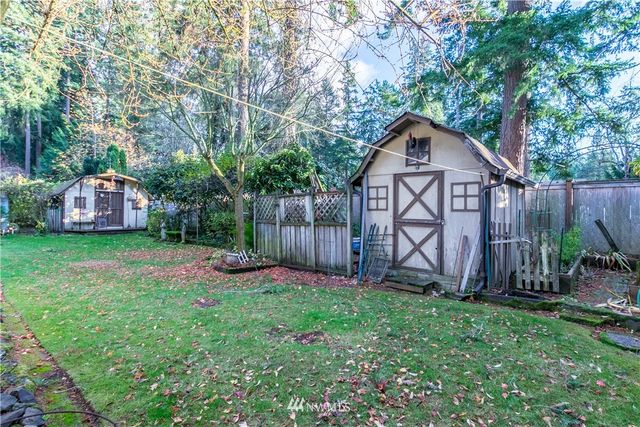 a view of a house with a yard and sitting area