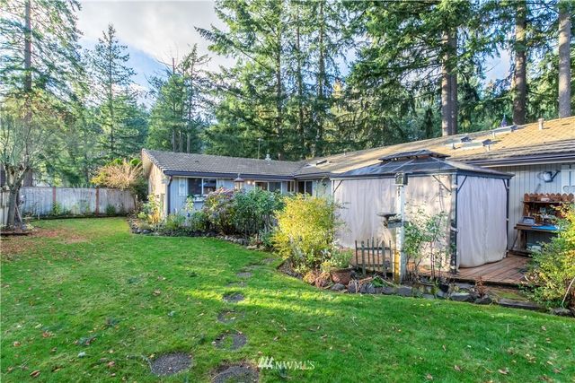 a view of a house with garden and a sitting area