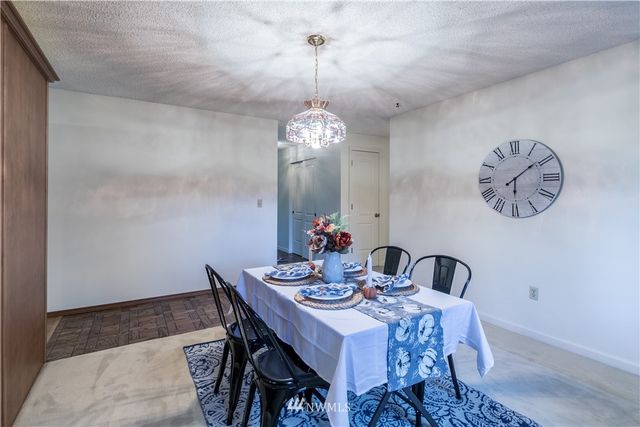 a dining room with a table and chairs