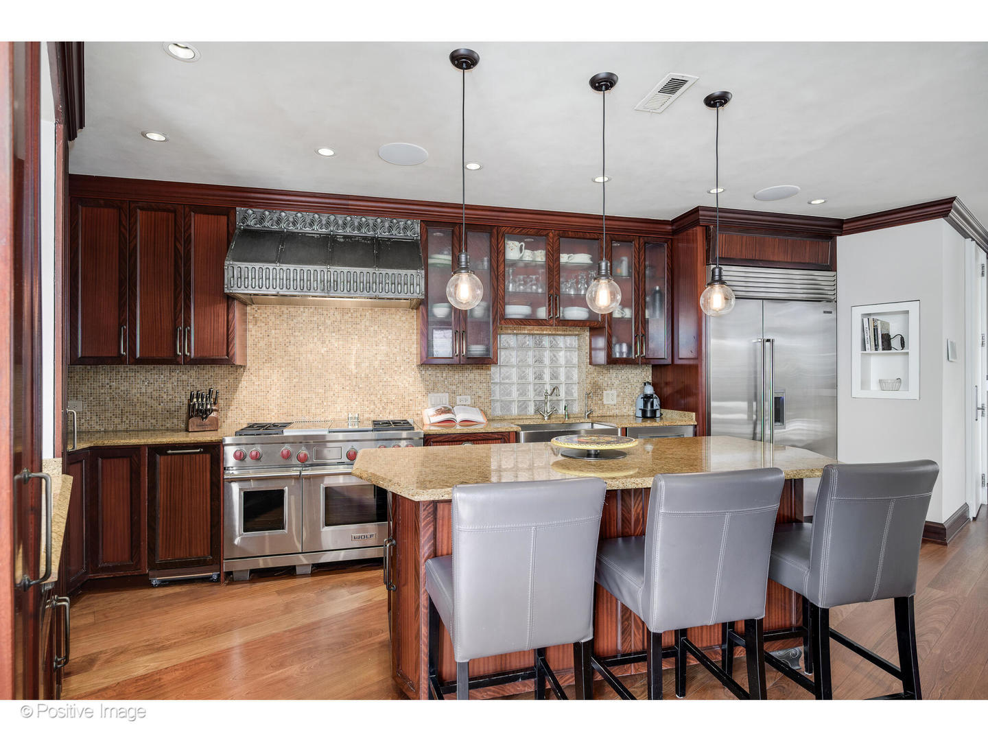 1811 North Howe Street Chicago, IL 60614 - Photo 13 of 42 a kitchen with stainless steel appliances granite countertop a stove top oven a refrigerator a sink and a dining table with chairs