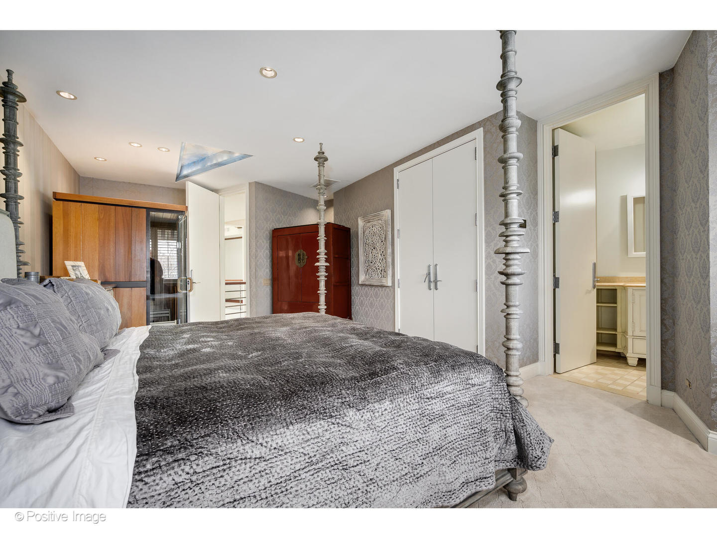 1811 North Howe Street Chicago, IL 60614 - Photo 32 of 42 a large bedroom with a large bed a chandelier and closet