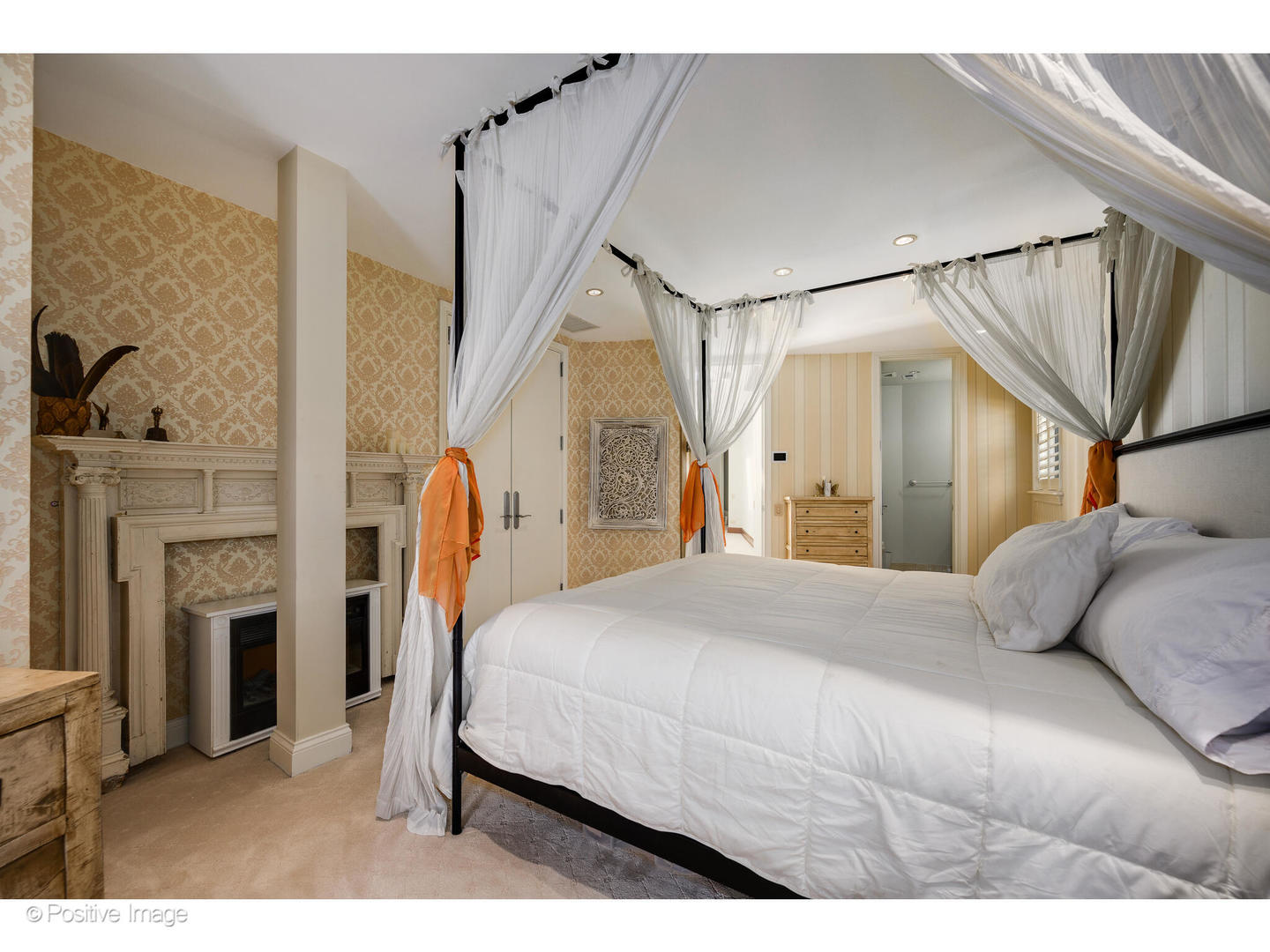 1811 North Howe Street Chicago, IL 60614 - Photo 35 of 42 a bedroom with a bed next to a fireplace with a flat tv screen and a fireplace