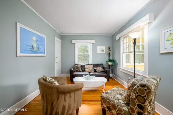 a bedroom with furniture and wooden floor