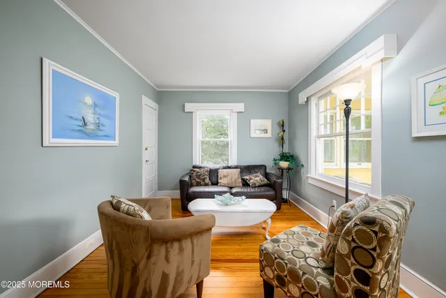 a bedroom with furniture and wooden floor