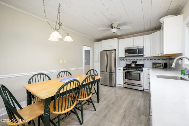 a view of a dining room with furniture and chandelier