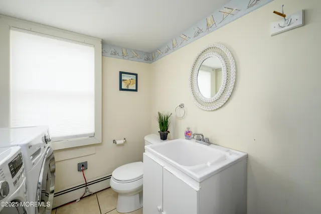 a bedroom with two beds and painting on the wall