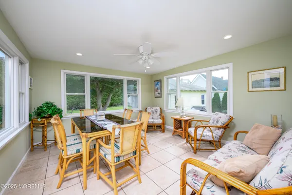 a living room with furniture and large windows