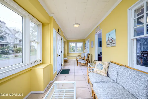 a living room with furniture and a floor to ceiling window