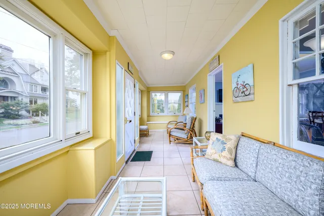 a living room with furniture and a floor to ceiling window