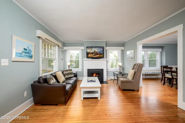 a living room with furniture a flat screen tv and a fireplace
