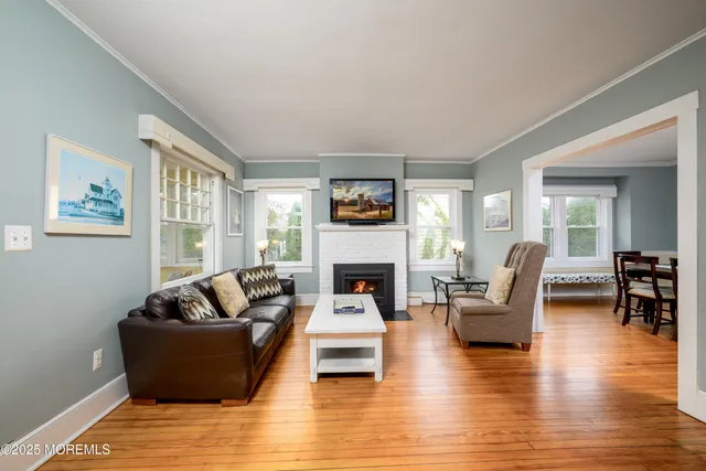 a living room with furniture a flat screen tv and a fireplace
