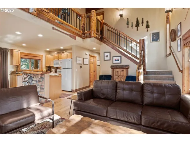 a living room with furniture or kitchen view and a wooden floor