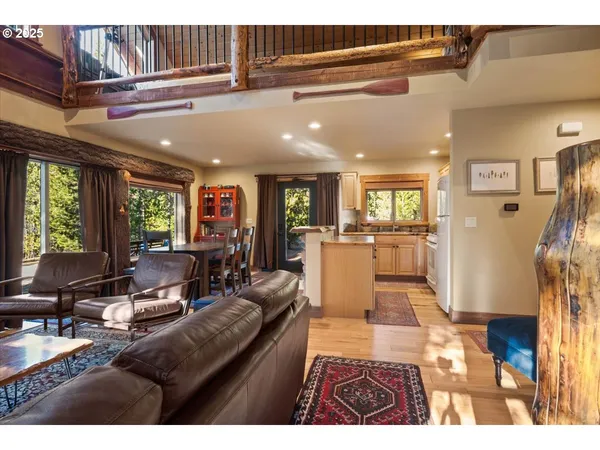 a living room with furniture wooden floor and a large window