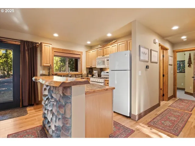 a kitchen with refrigerator and cabinets