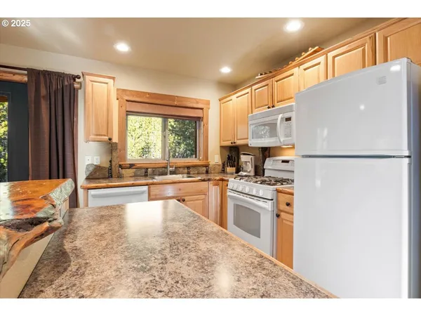 a kitchen with refrigerator a stove a sink and a refrigerator