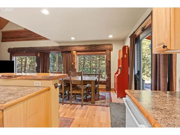 a dining hall with stainless steel appliances granite countertop a granite counter tops and a large window