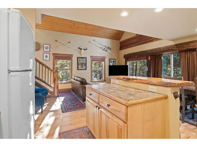 a living room with stainless steel appliances kitchen island granite countertop furniture and a kitchen view