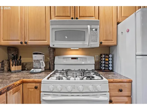 a white stove top oven sitting inside of a kitchen