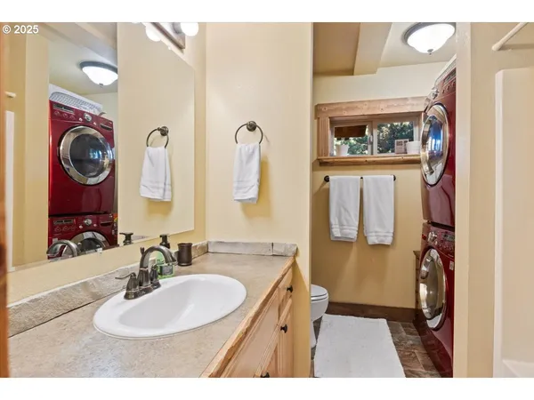 a bathroom with a sink mirror and toilet