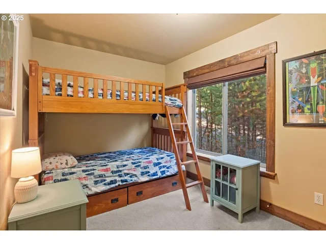 a living room with a bed furniture and a window