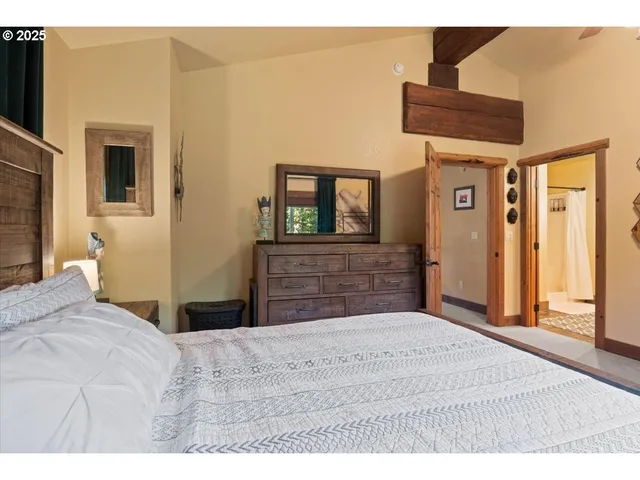 a bedroom with a bed and a dresser