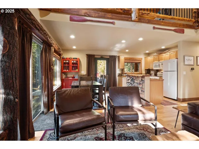 a living room with furniture and kitchen view