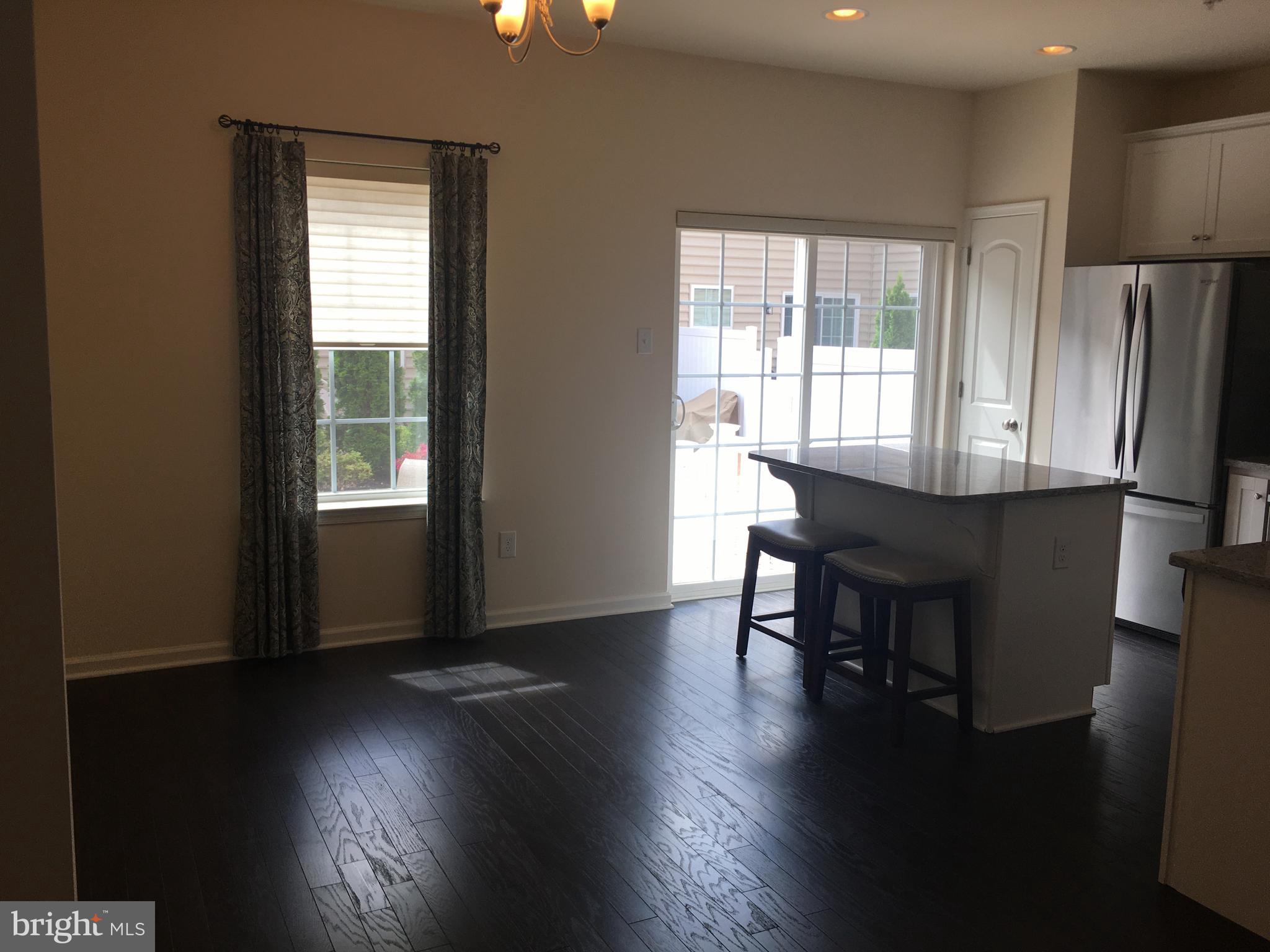 3600 Jacob Stout Road, Unit 15 Doylestown, PA 18902 - Photo 5 of 22 Kitchen dining area with hardwood floors.Slider