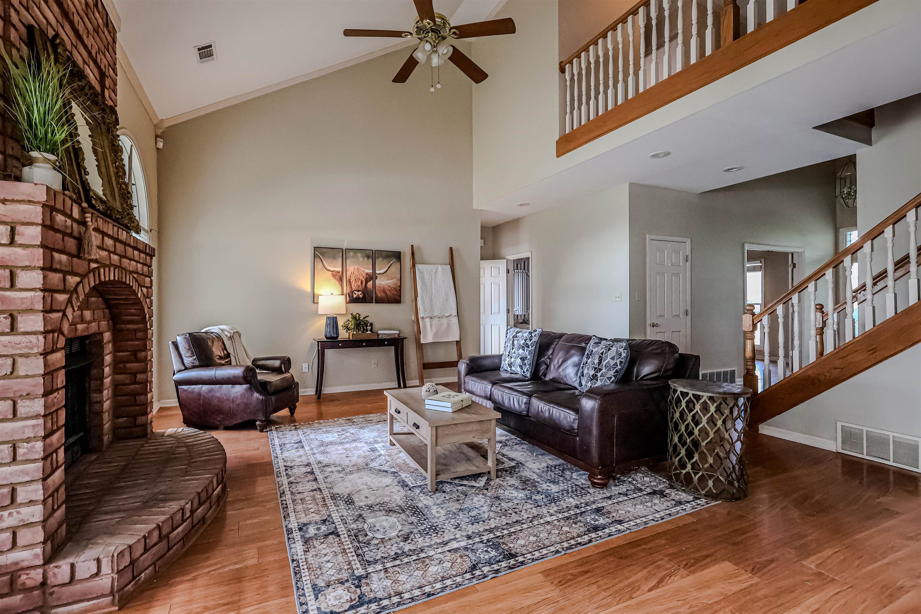 121 Reed Circle Drummonds, TN 38023 - Photo 8 of 38 Living area featuring a ceiling fan, wood finished floors, baseboards, and visible vents