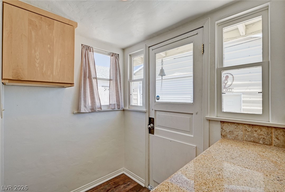 629 L Avenue Boulder City, NV 89005 - Photo 22 of 46 Doorway to outside with baseboards and wood finished floors