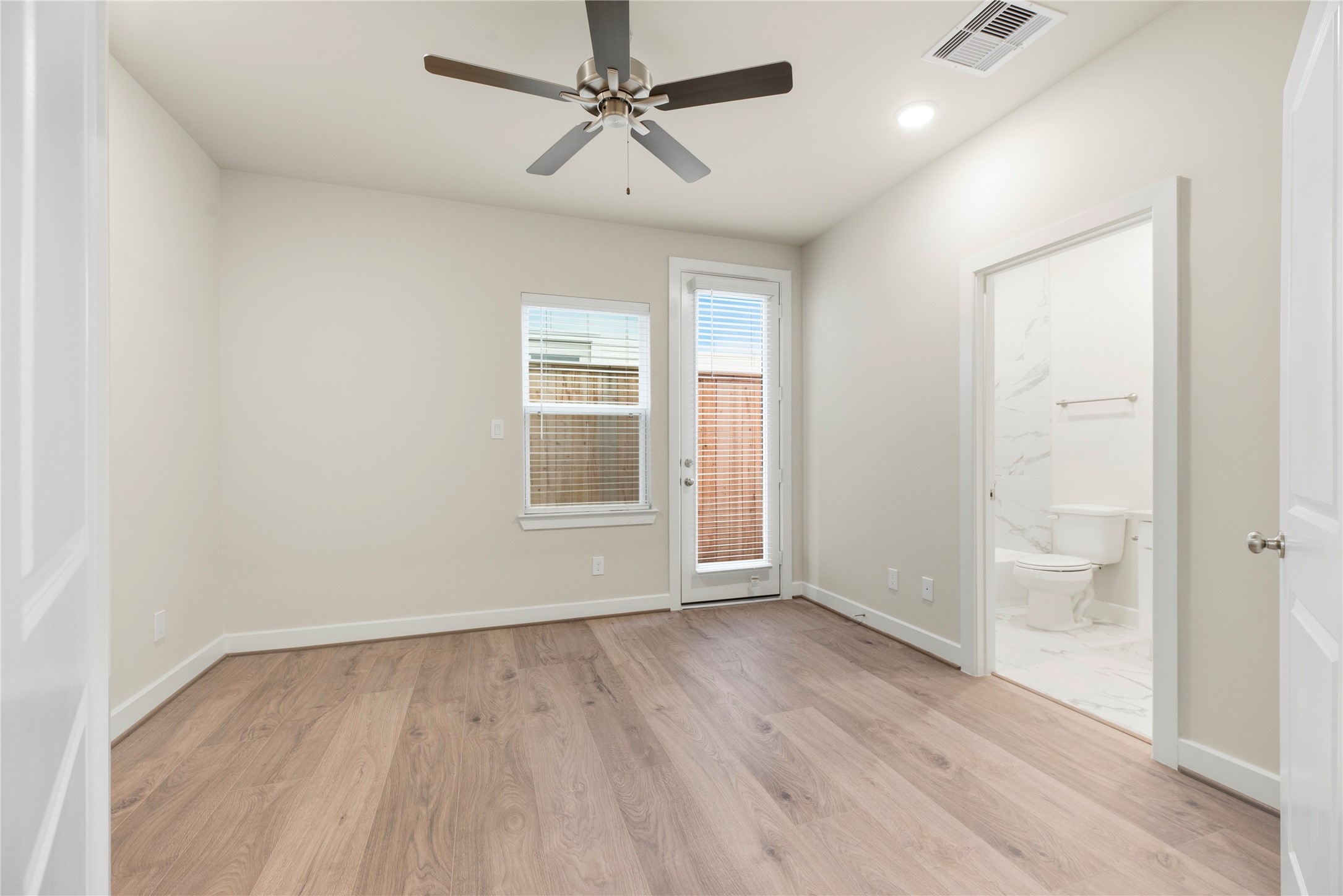 3075 Hicks Street Houston, TX 77007 - Photo 5 of 34 wooden floor in an empty room with a window