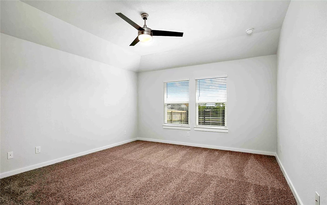 925 Kickapoo Lane College Station, TX 77845 - Photo 12 of 20 an empty room with a window and a ceiling fan