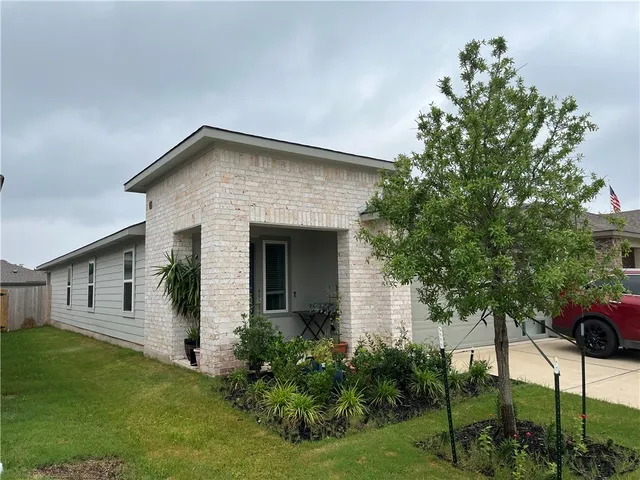 a front view of a house with a garden