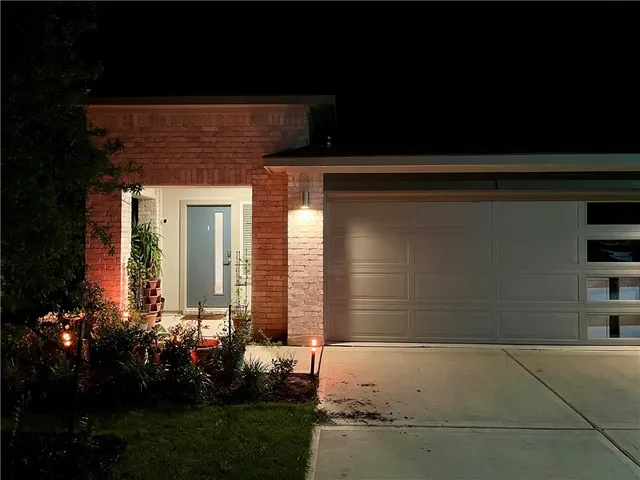 a front view of a house with a garden